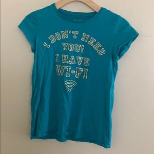 teal graphic T-shirt with gold writing.